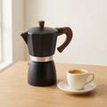 Stovetop coffee maker with espresso cup